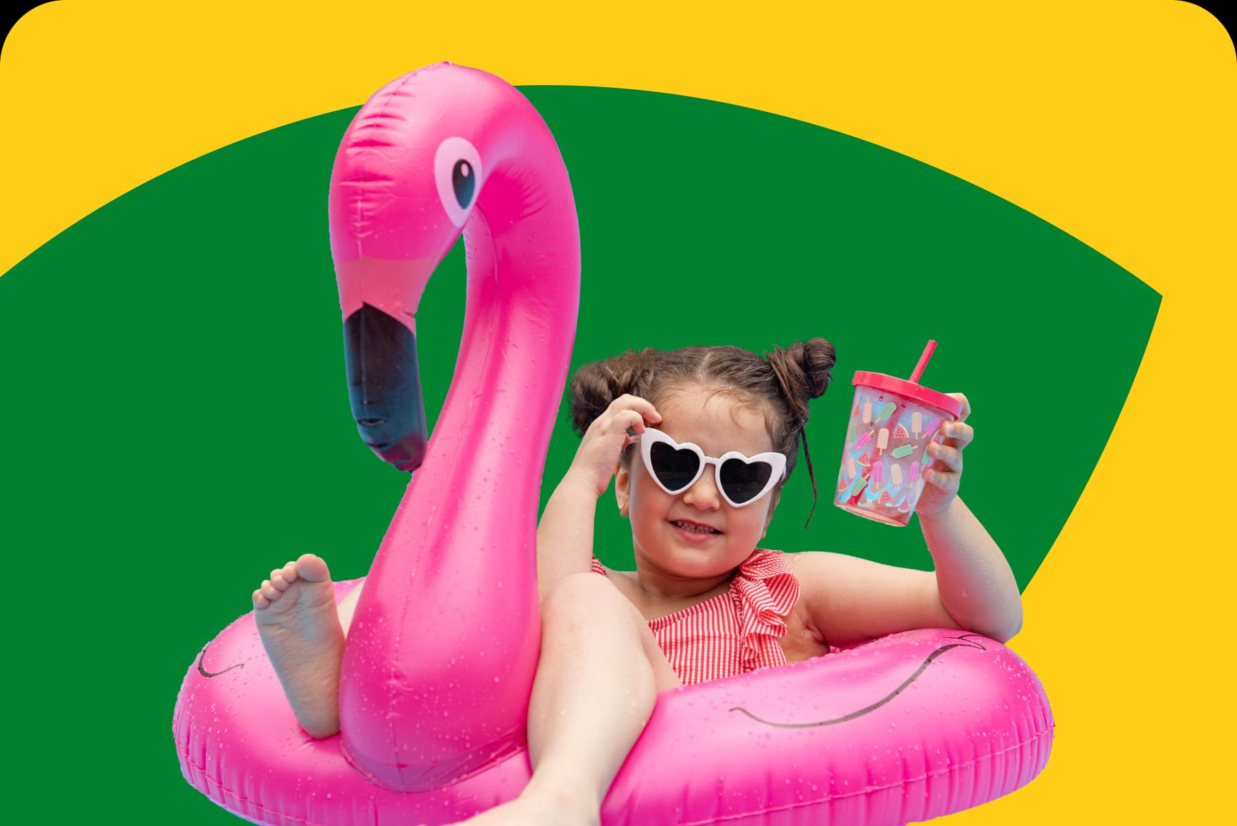 Image of a child on a pink flamingo inflatable.